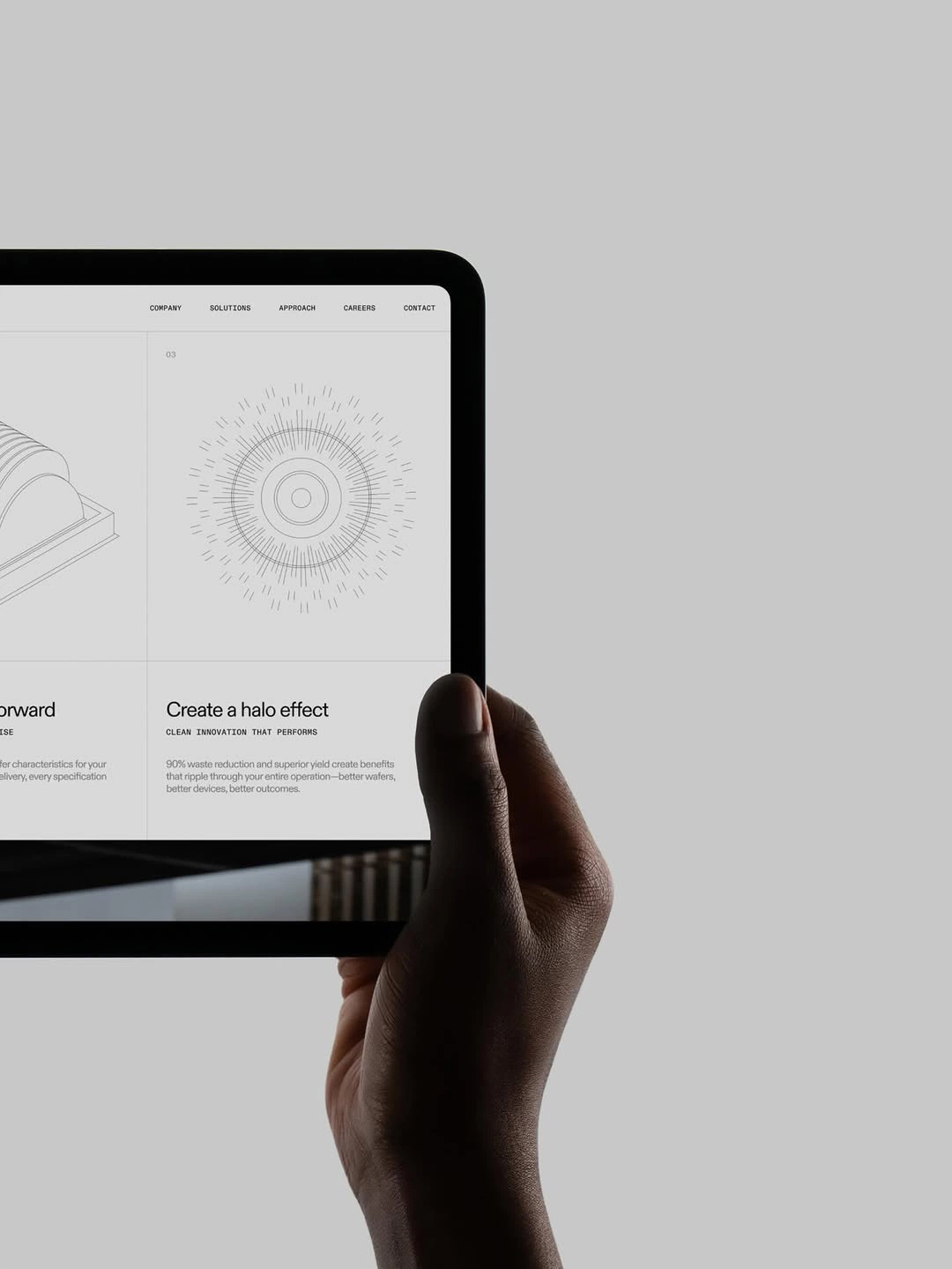 A hand holding a tablet with a technical product landing page